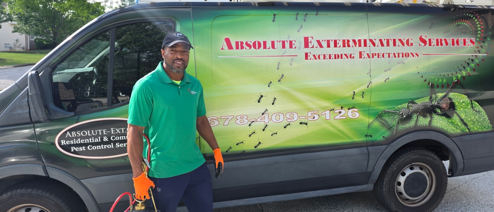 Absolute Exterminating technician and service van in the Atlanta metro area